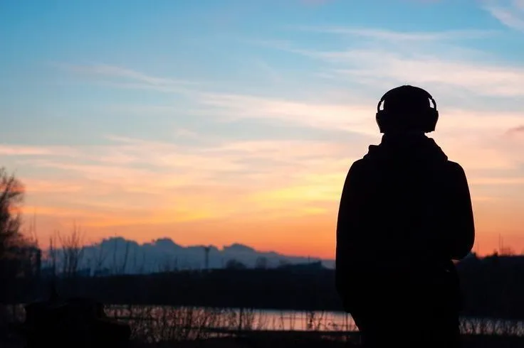 Artist at sunset wearing headphones